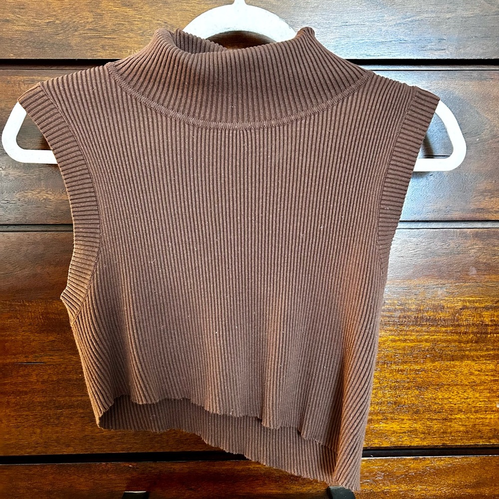 This is a Large knit turtle neck slanted crop top.